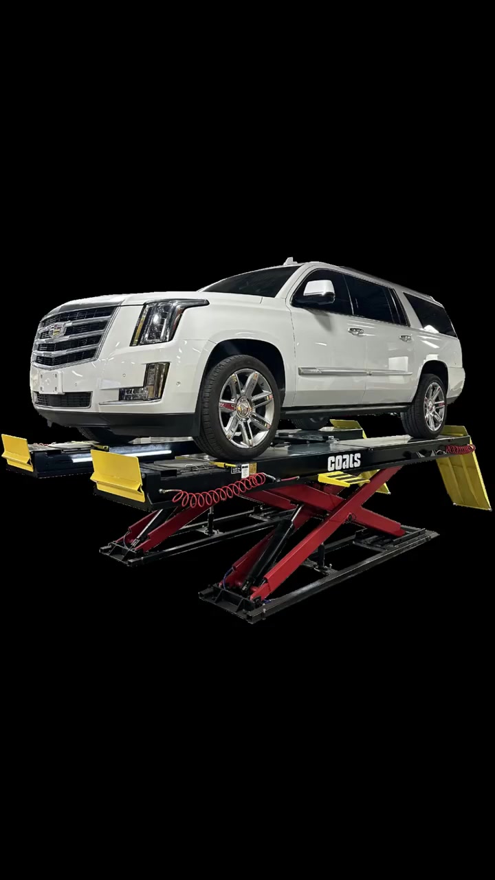 Coats supporting lift equipment in a wheel-service bay