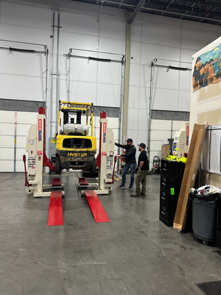 Construction and material-handling equipment raised with mobile column lifts