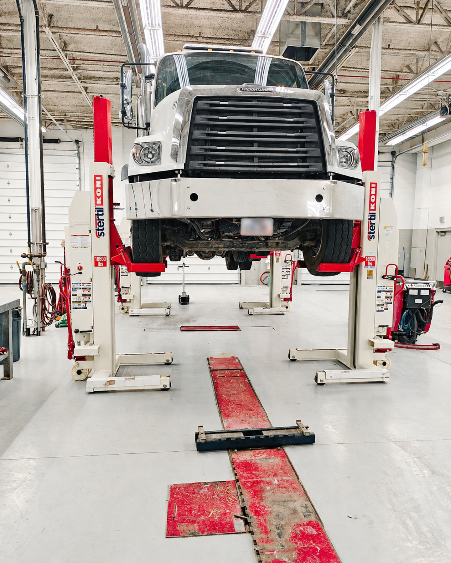 Commercial truck raised with Stertil-Koni mobile column lifts