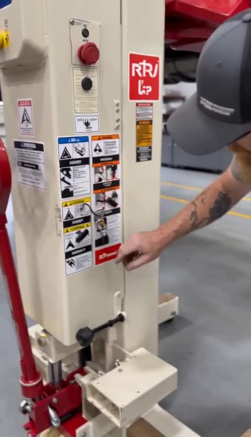 RML technician reviewing a Stertil-Koni mobile column lift in the field