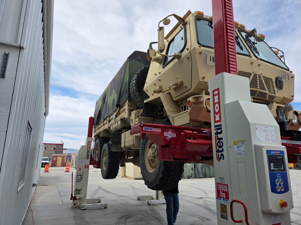 Specialized fleet vehicle positioned with mobile column lifting equipment