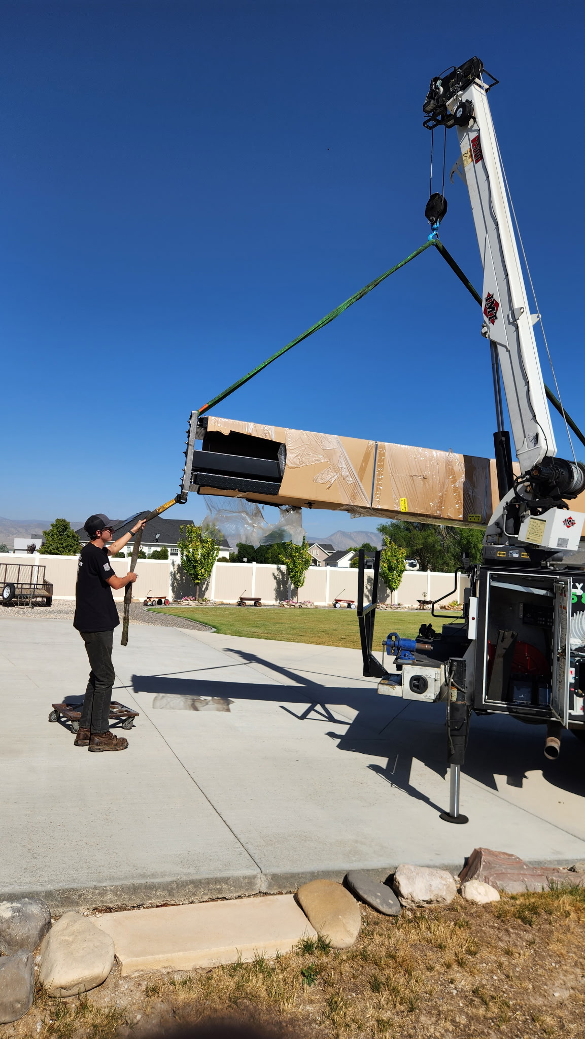 Tuxedo FB8K lift being delivered by crane to a home garage