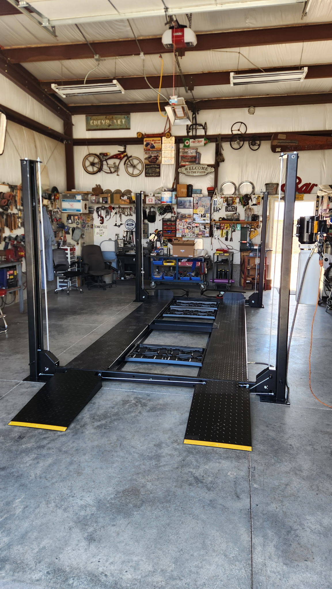 Completed Tuxedo FB8K four-post lift in a home garage
